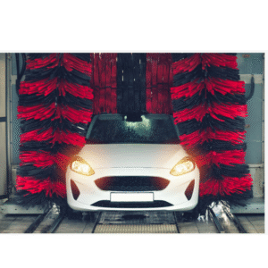 A car between two giant spinning brushes and a car wash 