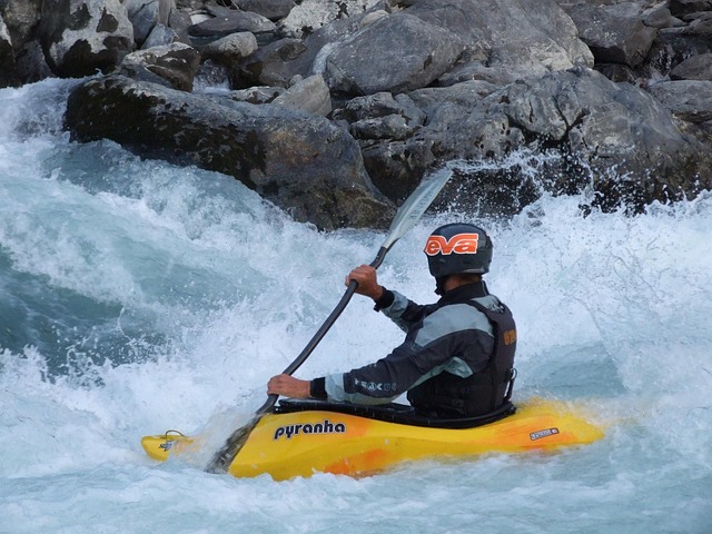 person in a yellow raft navigating rapids
